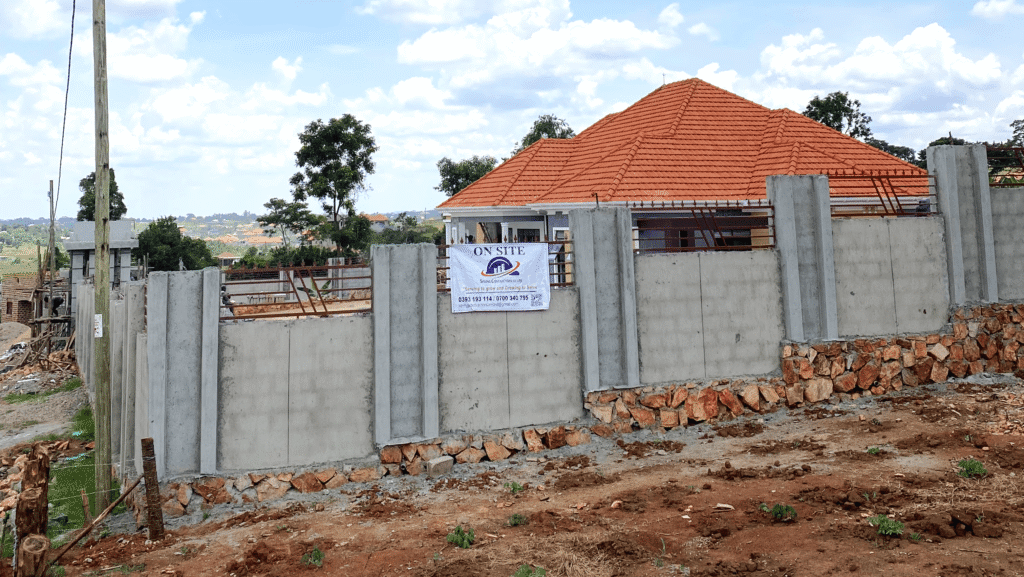 A construction site in Kampala being inspected by officials to ensure compliance with the 40,000 Shillings per square meter penalty rule.
