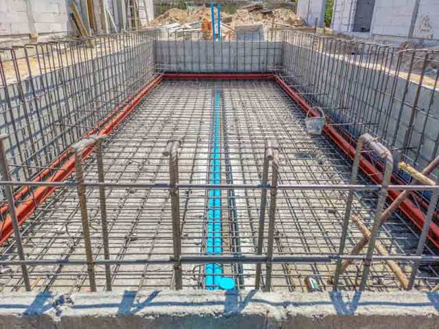 A structural engineer performing a slump test on fresh concrete at a construction site in Wakiso to ensure compliance with building standards