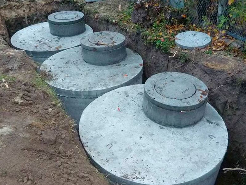 A technical comparison diagram of a Septic Tank vs. Bio-Digester being installed on a modern residential site in Kampala.